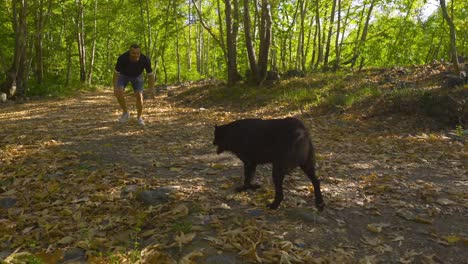 The-man-is-running-with-his-dog-in-the-forest.
